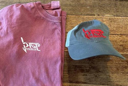 Image of front of TAG shirt and hat.